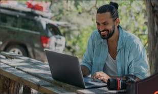 Photographer working outdoors on a laptop