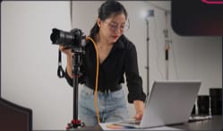 Photographer with a camera rig and laptop
